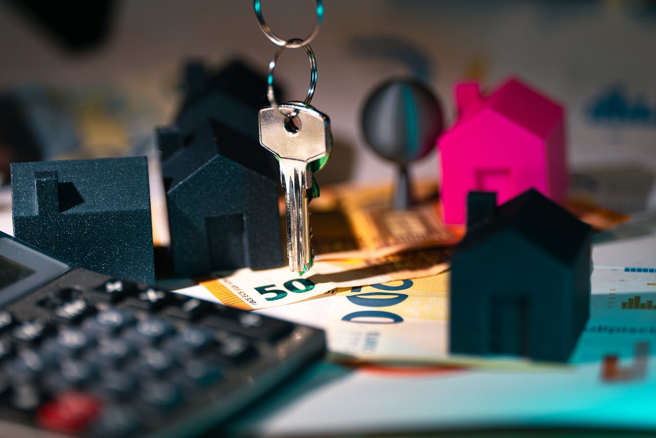 Home A symbolic representation of real estate finance featuring keys, model houses, and euro banknotes.